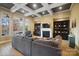 Elegant living room featuring coffered ceilings, a fireplace, built-in shelving, and large windows overlooking picturesque views at 226 Hermance Ln, Mooresville, NC 28117