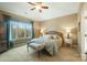 Light and airy main bedroom with a ceiling fan, carpet, bench, and large windows with an outside view at 226 Hermance Ln, Mooresville, NC 28117