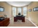 Well-lit home office features neutral paint, carpet, and multiple windows for natural light at 226 Hermance Ln, Mooresville, NC 28117