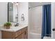 Cozy bathroom with a stylish vanity, modern fixtures, and a shower-tub combination with blue curtain at 230 Pond View Ln, Fort Mill, SC 29715