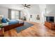 Bedroom with hardwood floors, a large window with patterned curtains, a bed and an angled ceiling at 230 Pond View Ln, Fort Mill, SC 29715