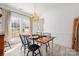 Bright dining room with a wood table, black chairs, and light colored floors at 230 Pond View Ln, Fort Mill, SC 29715