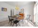 Formal dining room featuring stylish wood table, black chairs, and modern chandelier at 230 Pond View Ln, Fort Mill, SC 29715