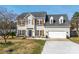 Charming two-story home with a well-manicured lawn, attached garage, and inviting front porch at 230 Pond View Ln, Fort Mill, SC 29715