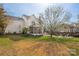Home exterior showcases a spacious backyard with a fire pit, seating, and a well-maintained lawn at 230 Pond View Ln, Fort Mill, SC 29715