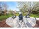 Cozy backyard fire pit area with three Adirondack chairs, perfect for outdoor gathering and relaxation at 230 Pond View Ln, Fort Mill, SC 29715