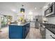 Modern kitchen with stainless steel appliances, large island, white cabinets, and hardwood floors at 230 Pond View Ln, Fort Mill, SC 29715