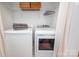 Functional laundry room with a washer, dryer, shelving and hanging rack for clothes at 230 Pond View Ln, Fort Mill, SC 29715