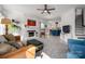 Bright living room features fireplace, hardwood floors, ceiling fan, and opens to modern kitchen at 230 Pond View Ln, Fort Mill, SC 29715