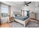 Bright main bedroom with a large window, ceiling fan and ensuite bathroom with sliding barn door at 230 Pond View Ln, Fort Mill, SC 29715