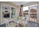 Inviting screened porch features a glass table with whimsical chair cushions and access to the interior at 230 Pond View Ln, Fort Mill, SC 29715