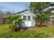 Backyard shed with double doors and surrounded by lush greenery and small palm trees at 230 Pond View Ln, Fort Mill, SC 29715