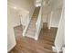 Inviting foyer featuring a staircase, hardwood floors, and ample natural light at 2617 Tuckton Ct, Charlotte, NC 28262