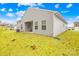 Exterior rear view of a gray home featuring a backyard with an outdoor patio and green grass under a blue sky at 3222 Maple Ridge Dr, Gastonia, NC 28052