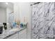 Modern bathroom vanity with granite countertop, white cabinets and a stylish marble-patterned shower curtain at 3222 Maple Ridge Dr, Gastonia, NC 28052