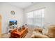 Bright living room with a comfortable armchair, wooden coffee table and large window with sheer curtains at 3222 Maple Ridge Dr, Gastonia, NC 28052