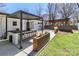 Outdoor oasis featuring a modern pergola, built-in bar, and lush green grass perfect for entertaining at 324 East End S Ave, Statesville, NC 28677
