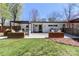 Backyard view with custom outdoor bar, wood planters, patio, and lush lawn at 324 East End S Ave, Statesville, NC 28677