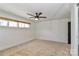 Bright bedroom features a ceiling fan, window, carpeted floors, and neutral paint at 324 East End S Ave, Statesville, NC 28677