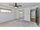 Spacious bedroom featuring a ceiling fan, mirrored closet, and natural light at 324 East End S Ave, Statesville, NC 28677