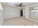 Spacious bedroom featuring a ceiling fan, mirrored closet and black door at 324 East End S Ave, Statesville, NC 28677