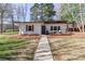 Beautifully landscaped home with a well-maintained lawn and charming front porch, enhancing curb appeal at 324 East End S Ave, Statesville, NC 28677