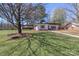 Spacious front yard with a well-maintained lawn, mature trees, and inviting home creating a welcoming atmosphere at 324 East End S Ave, Statesville, NC 28677