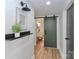 Stylish hallway with modern lighting, decor and a sliding barn door to the bathroom at 324 East End S Ave, Statesville, NC 28677
