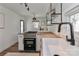 Well-lit kitchen boasting butcher block counters, white cabinets, and updated appliances at 324 East End S Ave, Statesville, NC 28677