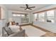 Bright living room featuring wood-trimmed windows, modern ceiling fan and decorative furnishings at 324 East End S Ave, Statesville, NC 28677