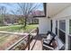 Inviting covered porch with wooden deck, chairs, and garden boxes, offering a relaxing outdoor space at 324 East End S Ave, Statesville, NC 28677