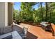 Large outdoor deck with a grill, dining table, seating area, and wooded view at 352 Nantucket Way, Rock Hill, SC 29732
