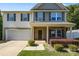 Charming two-story home with a well-manicured front yard and attached garage at 352 Nantucket Way, Rock Hill, SC 29732