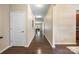 Long hallway with hardwood floors and neutral walls leads to various rooms, creating a seamless transition throughout the home at 352 Nantucket Way, Rock Hill, SC 29732