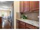 Close-up of the kitchen featuring stainless steel appliances, granite countertops, and dark wood cabinets for a modern touch at 352 Nantucket Way, Rock Hill, SC 29732