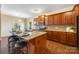 Kitchen island with granite countertop, seating, and dark wood cabinets creates a functional and stylish space for meal preparation at 352 Nantucket Way, Rock Hill, SC 29732