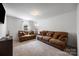 Spacious living room with two brown sofas, plush pillows, and neutral carpeting at 352 Nantucket Way, Rock Hill, SC 29732