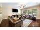 Spacious living room with plush leather sofas, large windows, and modern decor at 352 Nantucket Way, Rock Hill, SC 29732