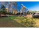 A grassy backyard featuring a shed, garden, and partially covered pool with fencing for privacy and security at 363 Arrowood Ave, Lancaster, SC 29720