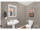 Small bathroom with sink, toilet, and decorative elements at 363 Arrowood Ave, Lancaster, SC 29720