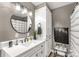 Stylish bathroom features a round mirror, modern vanity, and ample storage space at 363 Arrowood Ave, Lancaster, SC 29720