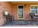 Close-up of a welcoming front porch with brick columns and chairs at 363 Arrowood Ave, Lancaster, SC 29720