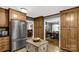 Kitchen featuring wood cabinetry, stainless steel refrigerator, and adjacent dining room at 363 Arrowood Ave, Lancaster, SC 29720