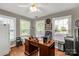 A professional office featuring a dark wood desk, windows with blinds, and tile flooring for a functional workspace at 363 Arrowood Ave, Lancaster, SC 29720