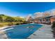 An in-ground pool is seen from backyard with cover, set near a brick home with a deck at 363 Arrowood Ave, Lancaster, SC 29720