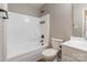 A bathroom featuring a white bathtub with a black faucet, sink and toilet at 3960 Town Center Rd, Harrisburg, NC 28075