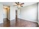 A vacant bedroom features dark, wood-look flooring and a ceiling fan at 3960 Town Center Rd, Harrisburg, NC 28075