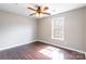 A cozy bedroom with wood floors, ceiling fan and ample natural light at 3960 Town Center Rd, Harrisburg, NC 28075