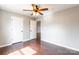 Bright bedroom featuring hardwood floors, neutral walls, ceiling fan, and closet at 3960 Town Center Rd, Harrisburg, NC 28075