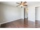 A naturally lit bedroom with wood flooring and a ceiling fan at 3960 Town Center Rd, Harrisburg, NC 28075